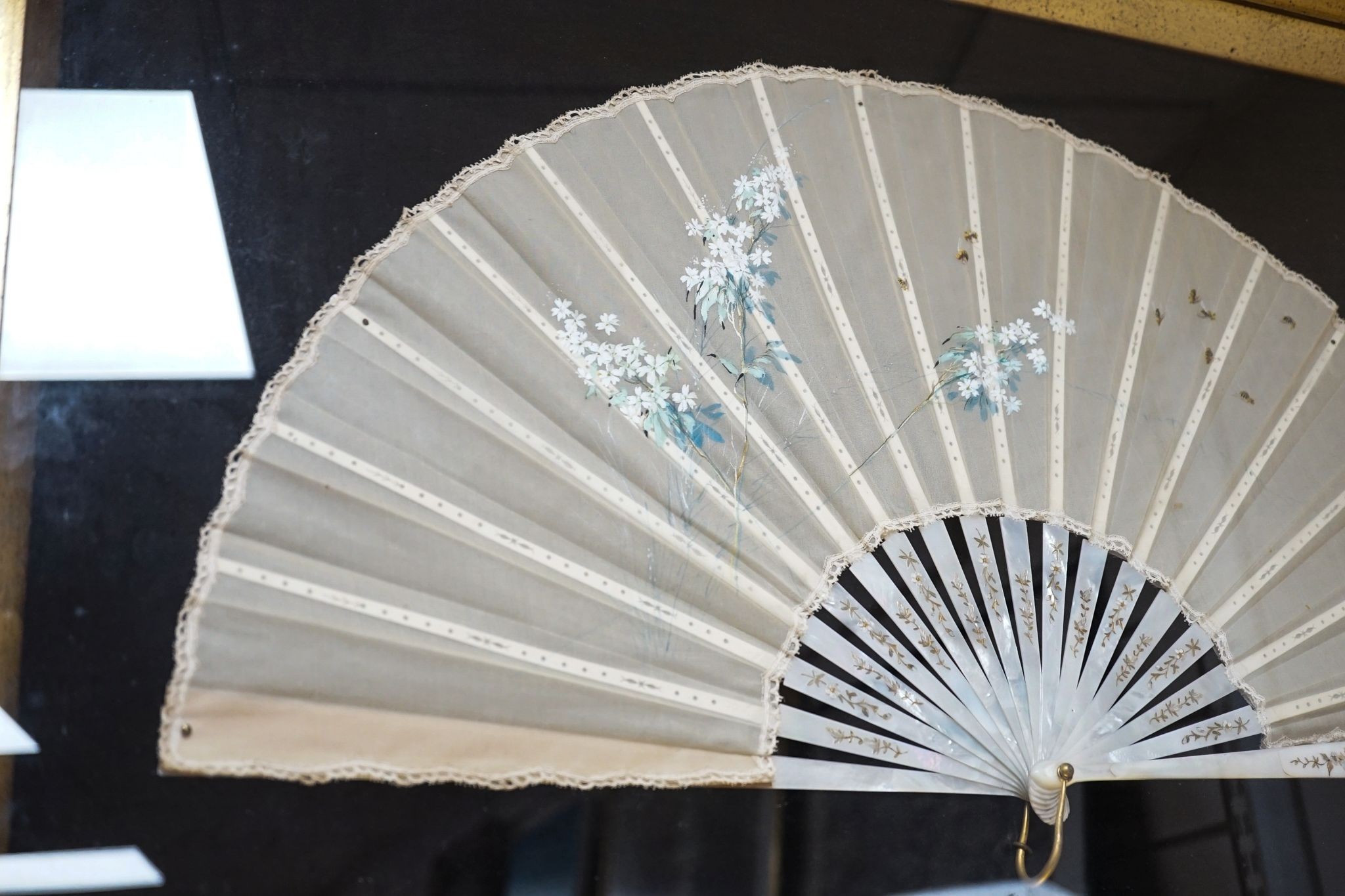 A framed 19th century French mother of pearl and painted silk fan, approx. 60cm long excl frame